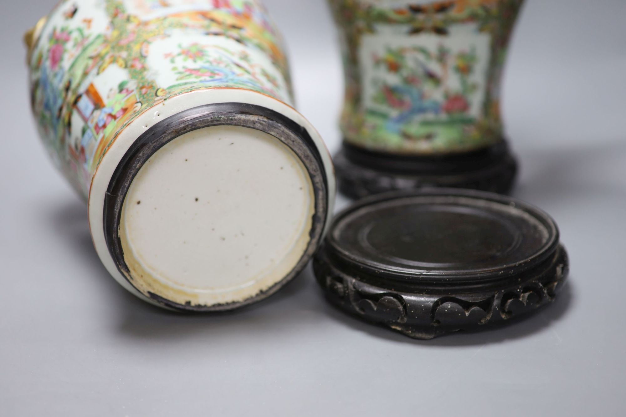 A pair of 19th century Cantonese vases and covers, with later stands, overall height 44cm (a.f.)